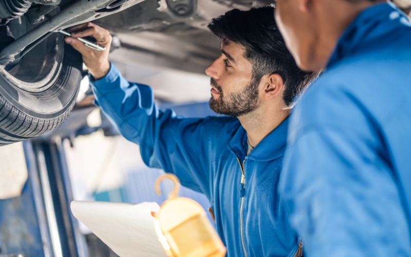 Technician servicing a vehicle