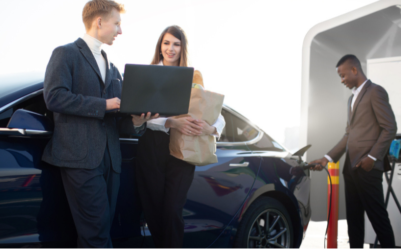 Salesman assisting woman with car search