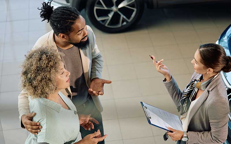 couple in a car dealership