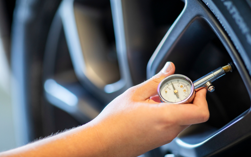 Person checking their tyre pressure