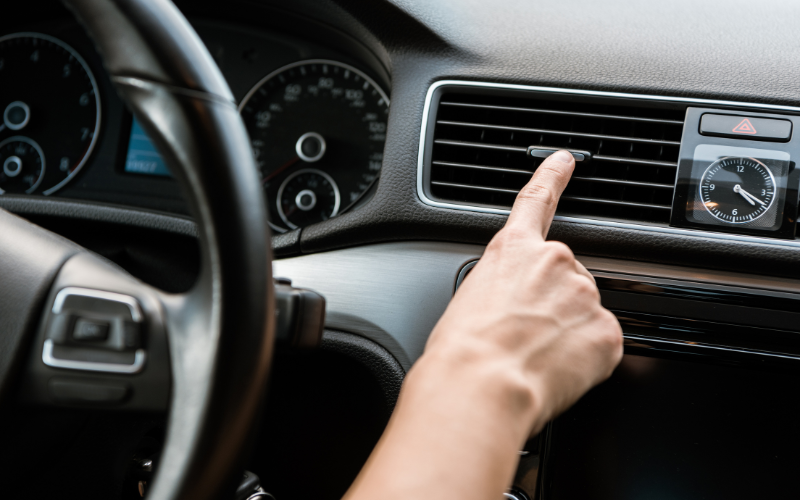 Person adjusting the air conditioning vents inside their vehicle